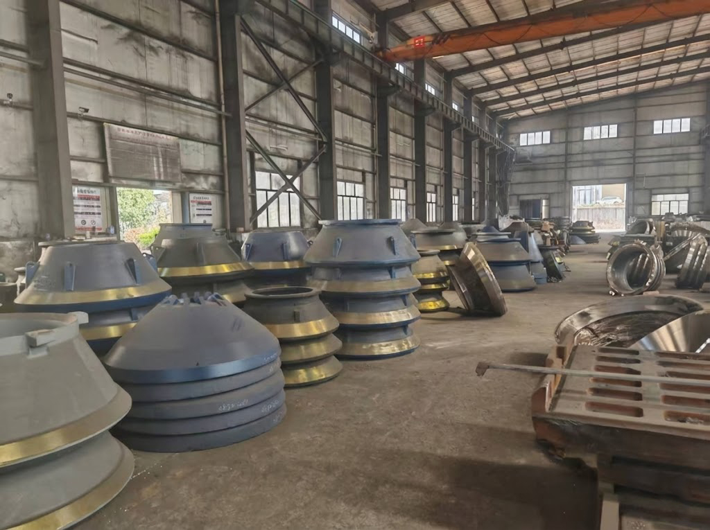 A handshake in front of a warehouse of crusher parts